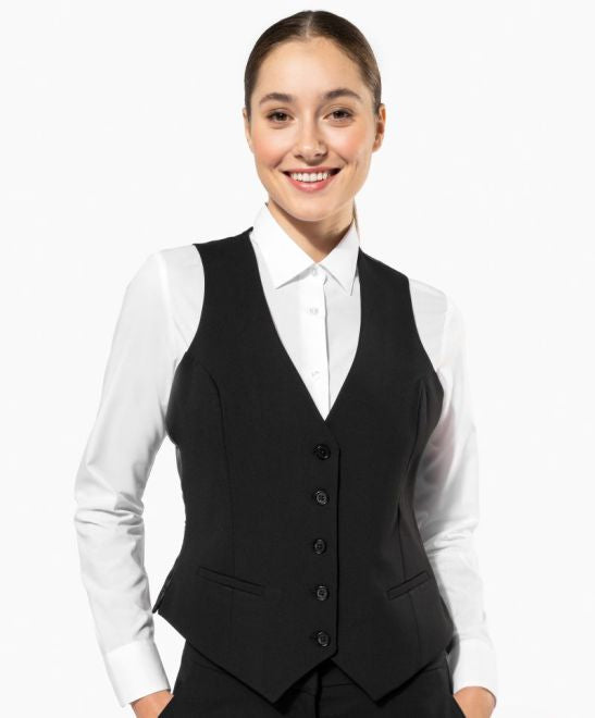 Ženski poslovni brezrokavnik Kariban K502, eleganten in moderen, prikazan na modelu v črni barvi.